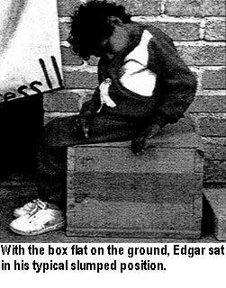 With the box flat on the ground, Edgar sat in his typical slumped position.