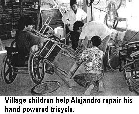 Village children help Alejandro reparr his hand powered tricycle.