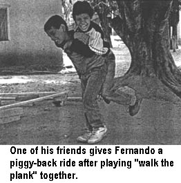 One of his friends gives Fernando a piggy-back ride after playing "walk the plank" together.