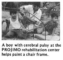 A boy with cerebral palsy at the PROJIMO rehabilitation center helps paint a chair frame.