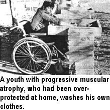 A youth with progressive muscular atrophy, who had been overprotected at home, washes his own clothes.
